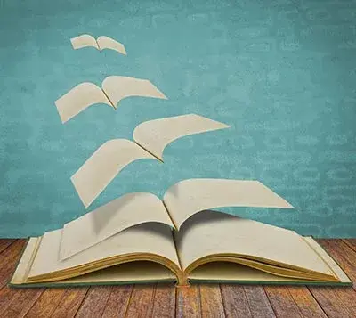 L'illustration d'un livre ouvert dont les pages s'envolent les unes après les autres. Symbolise la liberté.